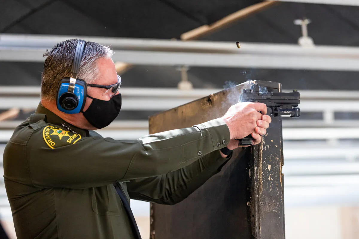 Orange County Sheriff Don Barnes fires his weapon at the Orange County Sheriff's Department shooting range in Orange, Calif., on March 30, 2021. (John Fredricks/The Epoch Times)
