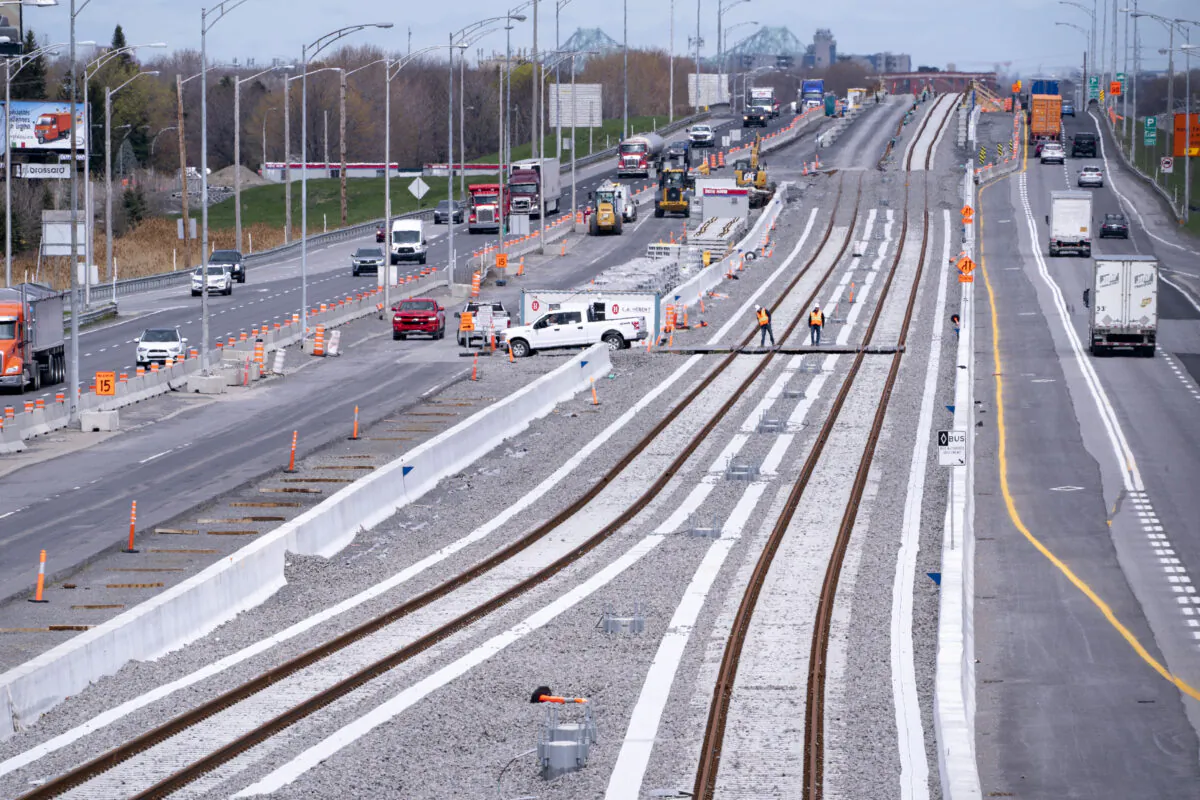 Construction workers on the site of the Réseau Express Métropolitain (REM), a major public transit project, in Brossard, Quebec, on May 11, 2020. The REM is a major infrastructure project partly funded by the Canada Infrastructure Bank. (Paul Chiasson/The Canadian Press)