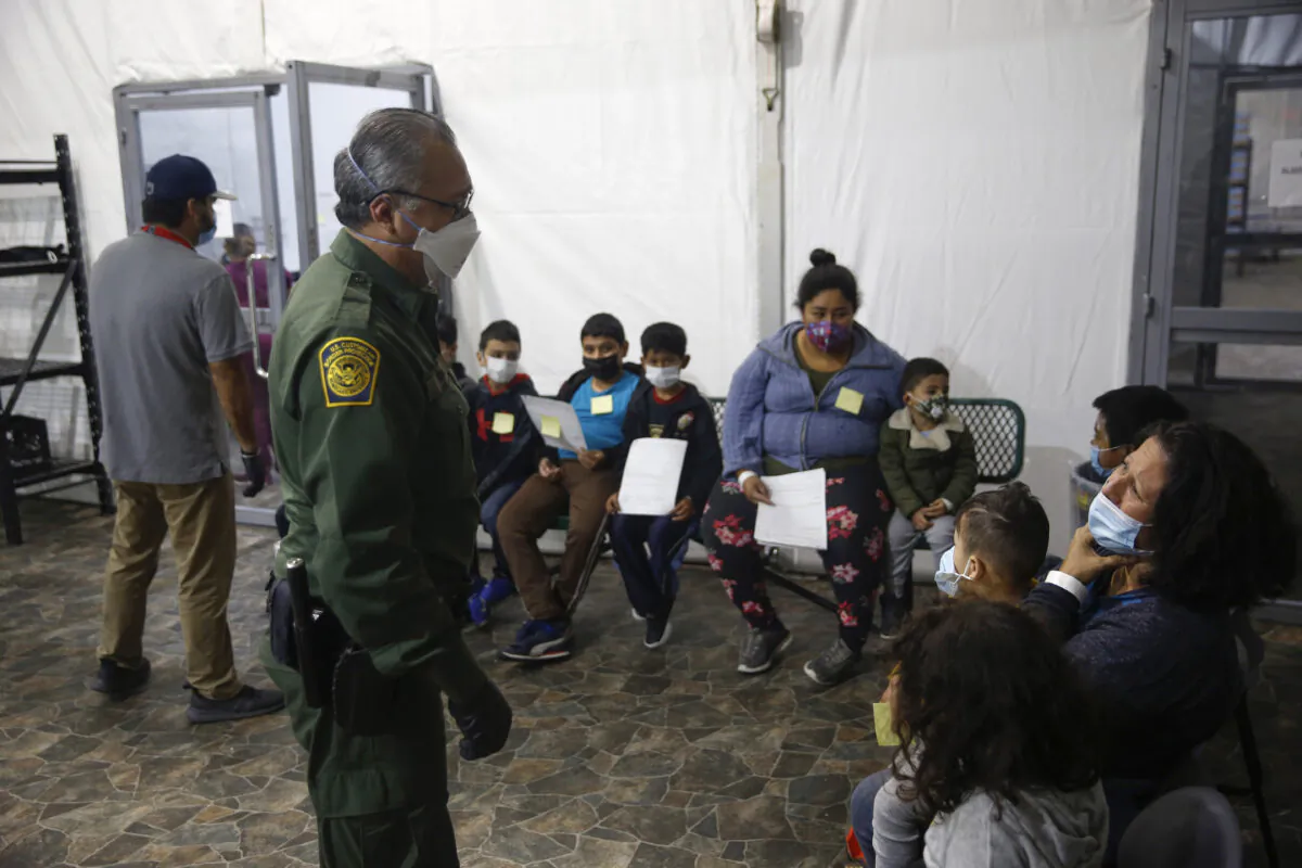 Migrants are processed at the intake area of the U.S. Customs and Border Protection facility, the main detention center for unaccompanied children in the Rio Grande Valley, in Donna, Texas, on March 30, 2021. (AP Photo/Dario Lopez-Mills, Pool)