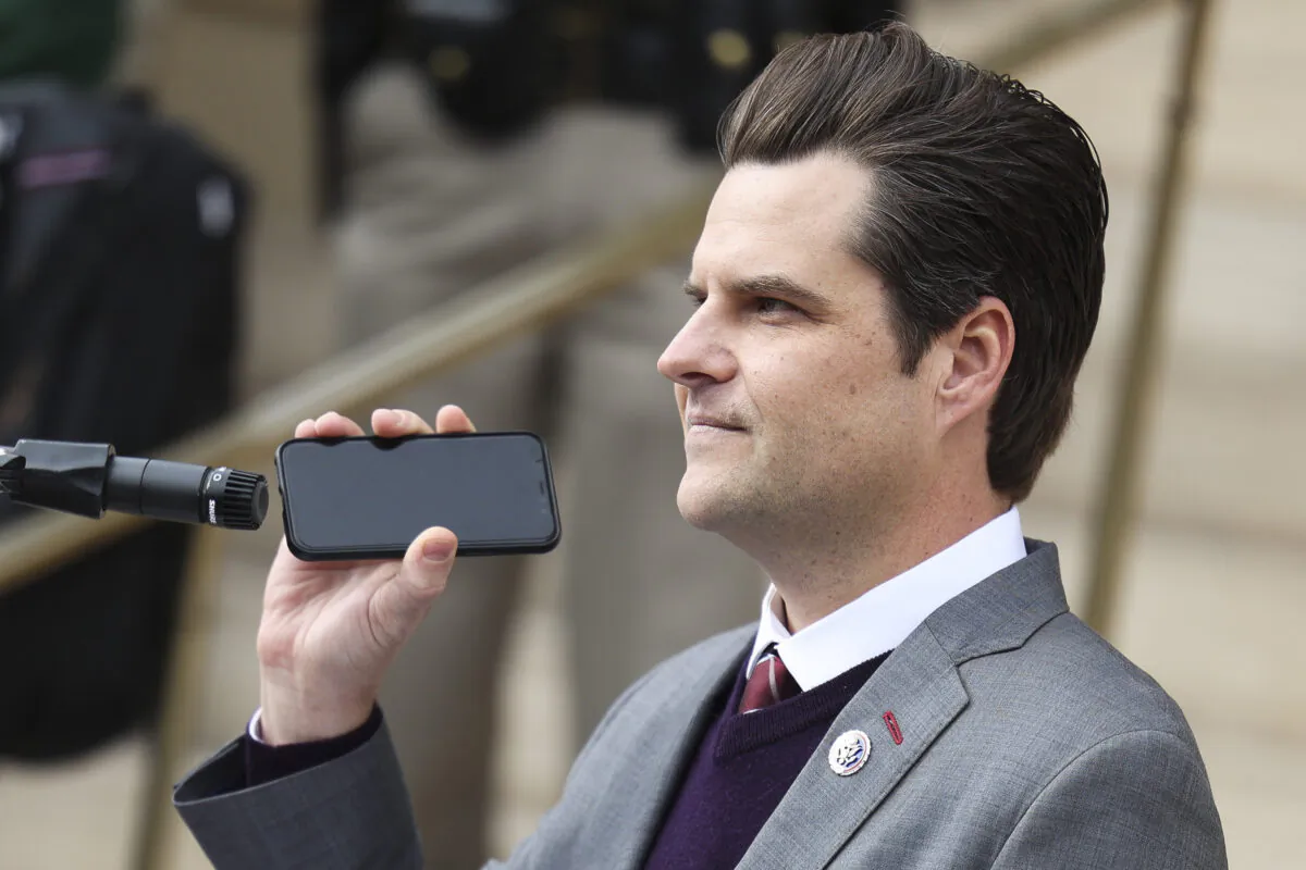 Rep. Matt Gaetz (R-Fla.) holds a phone to the microphone as Donald Trump Jr. speaks remotely to a crowd during a rally against Rep. Liz Cheney (R-WY) in Cheyenne, Wyo., on Jan. 28, 2021. (Michael Ciaglo/Getty Images)