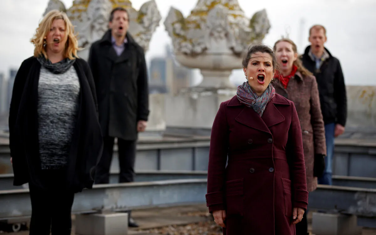 The choir of London's Royal Opera House perform on the rooftop of the Royal Opera House to celebrate Good Friday and the arrival of spring in London, Britain, on March 25, 2021. (John Sibley/Reuters)