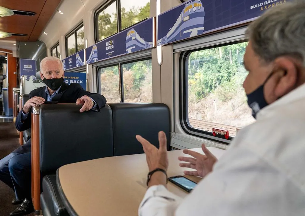 Current U.S. President Joe Biden speaks with United Steelworkers Union President Thomas Conway, right, aboard his train as it travels to Pittsburgh, in this Sept. 30, 2020 file photo. The largest industrial union in North America is vowing to protect Canadian businesses and workers from the perils of protectionism in the United States. (THE CANADIAN PRESS/AP -Andrew Harnik)