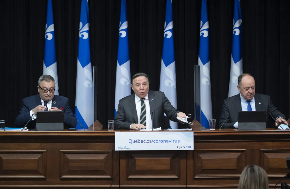 Quebec Premier Francois Legault, centre, speaks during a news conference on the COVID-19 pandemic in Quebec City, Canada, on March 31, 2021. (Jacques Boissinot/The Canadian Press)