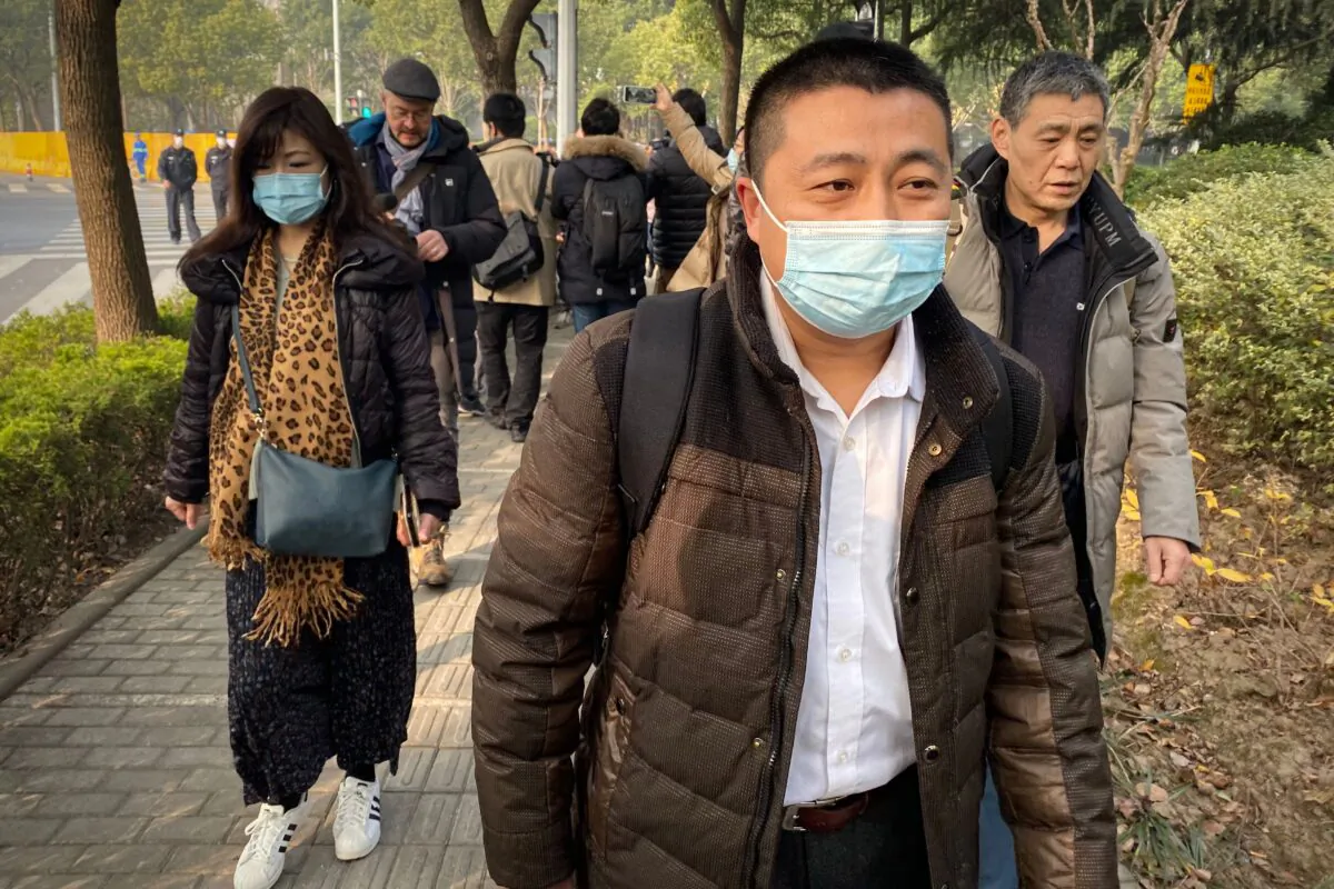 Lawyer Ren Quanniu (C), representing Chinese citizen journalist Zhang Zhan who reported on the virus outbreak, arrives at the Shanghai Pudong New District People's Court where Zhang is set for trial in Shanghai on Dec. 28, 2020. (Leo Ramirez/AFP via Getty Images)