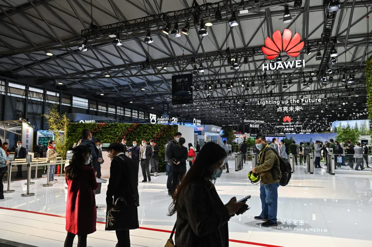 People visit a Huawei booth during the Mobile World Congress in Shanghai on Feb. 23, 2021. (Hector Retamal/AFP via Getty Images)