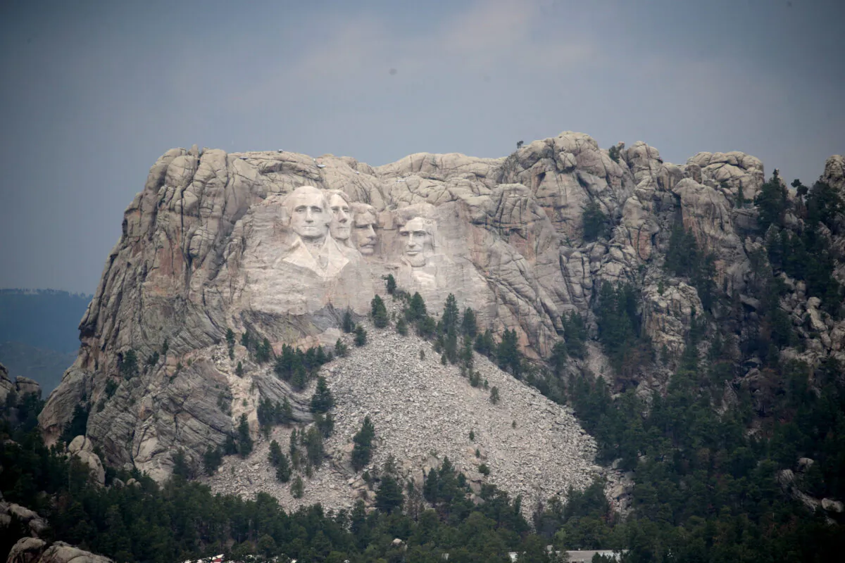 The busts of presidents George Washington, Thomas Jefferson, Theodore Roosevelt and Abraham Lincoln tower over the Black Hills at Mount Rushmore National Monument near Keystone, S.D., on July 2, 2020. (Scott Olson/Getty Images)