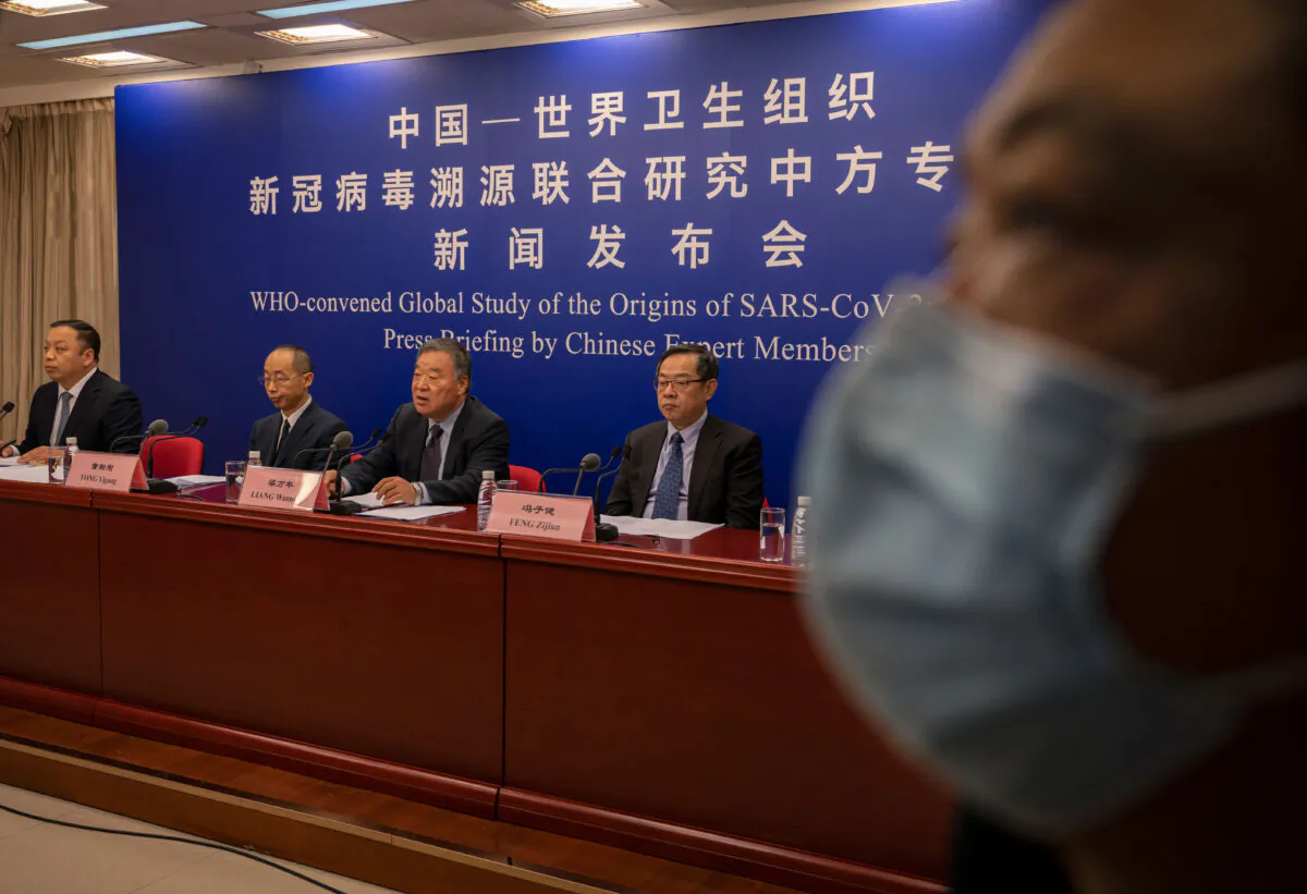 Head of the Expert Group on COVID Response at China's National Health Commission Liang Wannian, center, answers a question as he sits with colleagues Feng Zijian, right, Tong Yigan, second left, at a press conference addressing the World Health Organization (WHO) report on the origins of SARS-CoV-2, at the National Health Committee in Beijing, China, on March 31, 2021. (Kevin Frayer/Getty Images)