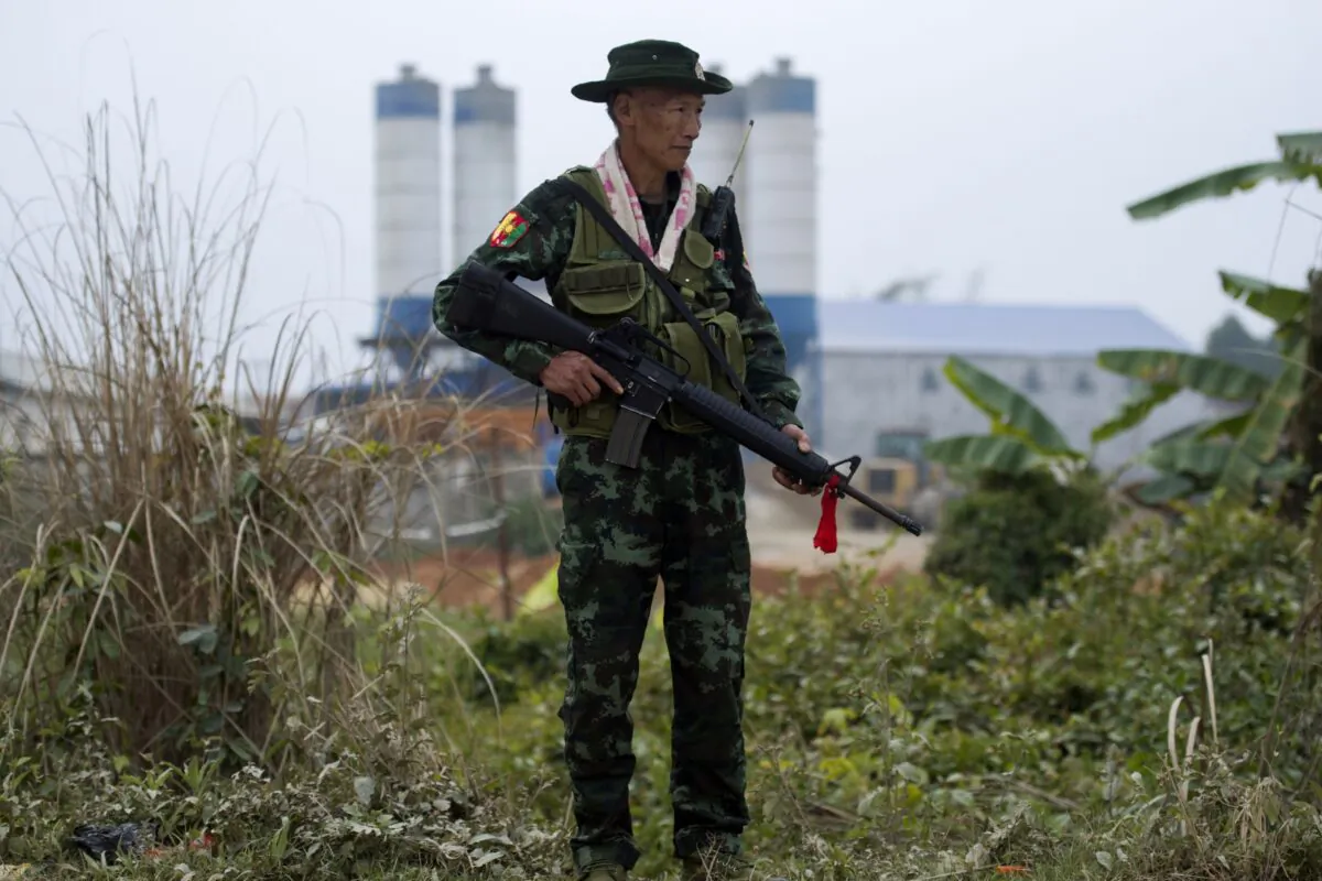 An armed Pan Say militiaman securing a bridge in Muse in Shan state, Burma's main gateway to China, on Jan. 12, 2019. (Ye Aung Thu/AFP via Getty Images)