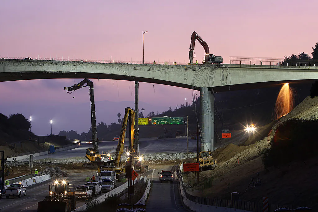 In this file photo, workers demolish the south side of Mulholland overpass on the 405 freeway on July 16, 2011 in Los Angeles, Calif. The bridge was demolished as part of a $1 billion project to add carpool lanes and make other improvements along the 405 freeway from Orange County to the city of San Fernando.   (David McNew/Getty Images)