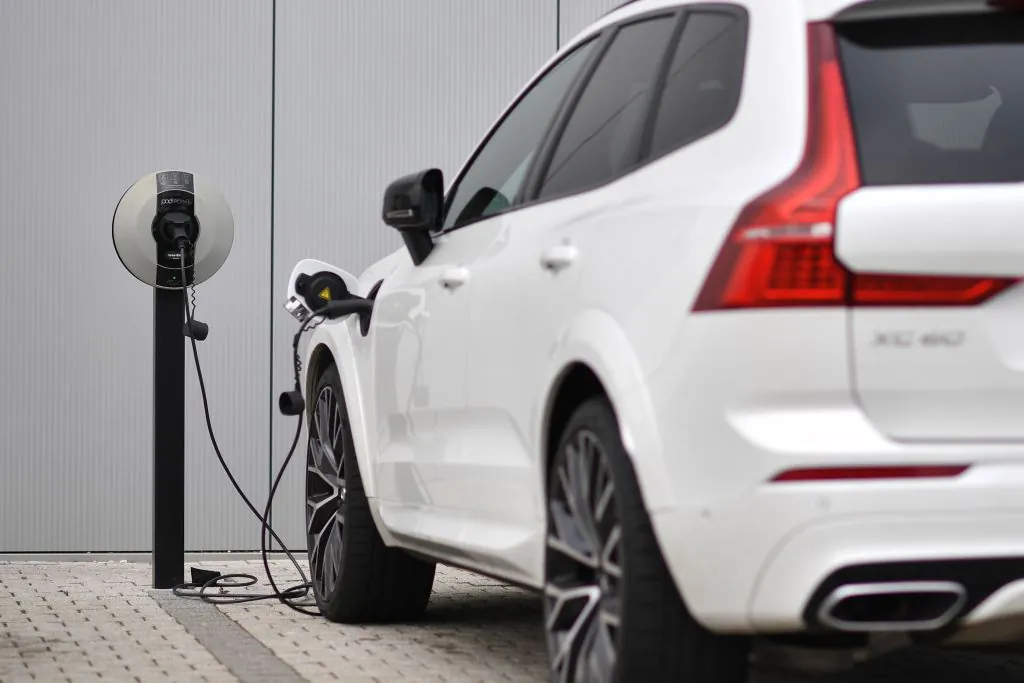 A Volvo XC60 hybrid car is seen plugged into a charging point outside a Volvo dealership in Reading, west of London, on March 2, 2021. (Ben Stansall/AFP via Getty Images)