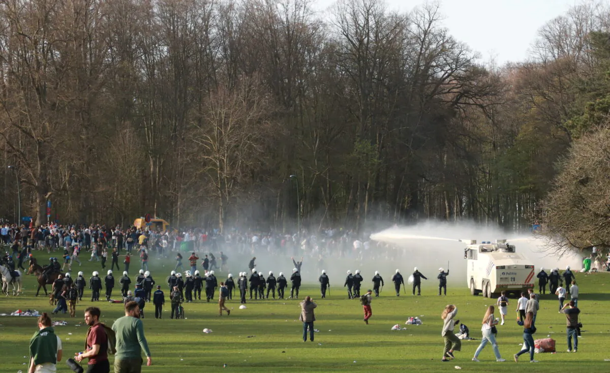 Belgian police forces disperse young people gathering at the Bois de la Cambre/Ter Kamerenbos park for a party in defiance of Belgium's CCP virus social distancing measures and restrictions, in Brussels on April 1, 2021. (Clement Rossignol/Reuters)