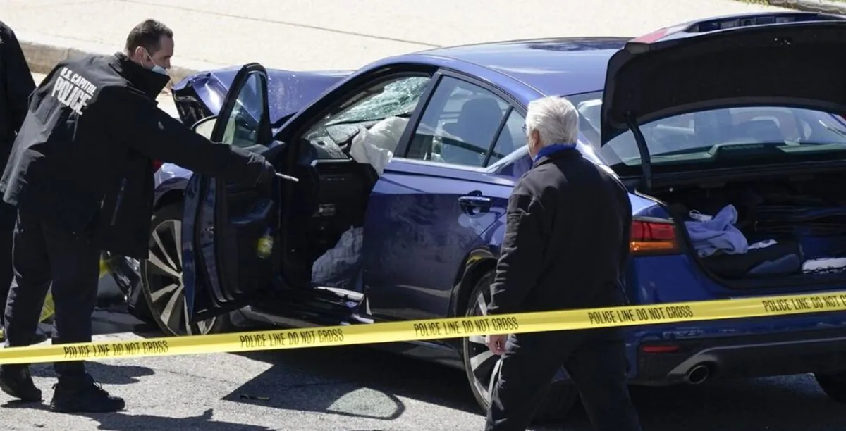 U.S. Capitol Police officers stand near a car that crashed into a barrier on Capitol Hill in Washington on April 2, 2021. (J. Scott Applewhite/AP Photo)
