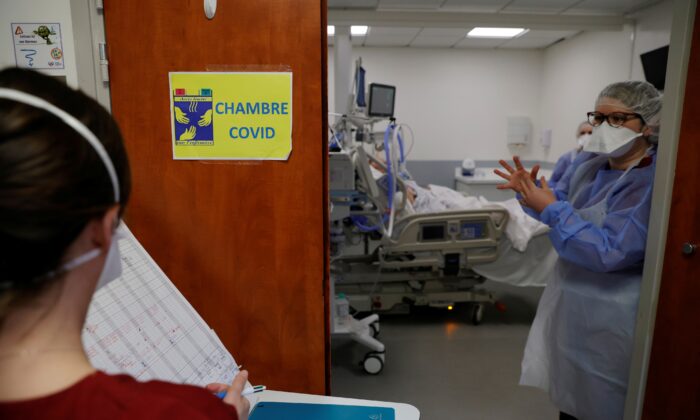 On April 1, 2021, a health worker wearing protective equipment is working in the intensive care unit (ICU) where a patient suffering from coronavirus disease (COVID-19) is treated at the Cambre Hospital in France.  (Pascal Rossignol / Reuters)