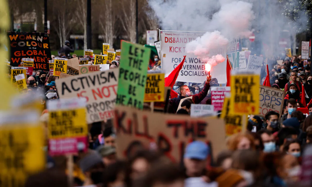 Demonstrators taking part in a 'Kill The Bill' protest against the government's Police, Crime, Sentencing, and Courts Bill hold up placards as they march in central London on April 3, 2021. (Tolga Akmen/AFP via Getty Images)