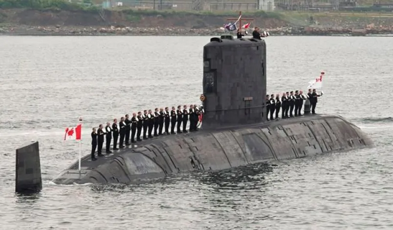 Sailors line up on Canadian submarine HMCS Corner Brook to salute Queen Elizabeth II during an international fleet review on June 29, 2010, in Halifax. An internal Defence Department report that says an errant test on one of Canada’s four beleaguered submarines last year caused permanent damage to the vessel that will continue to pose a risk over the long term. (Paul Chiasson/The Canadian Press)