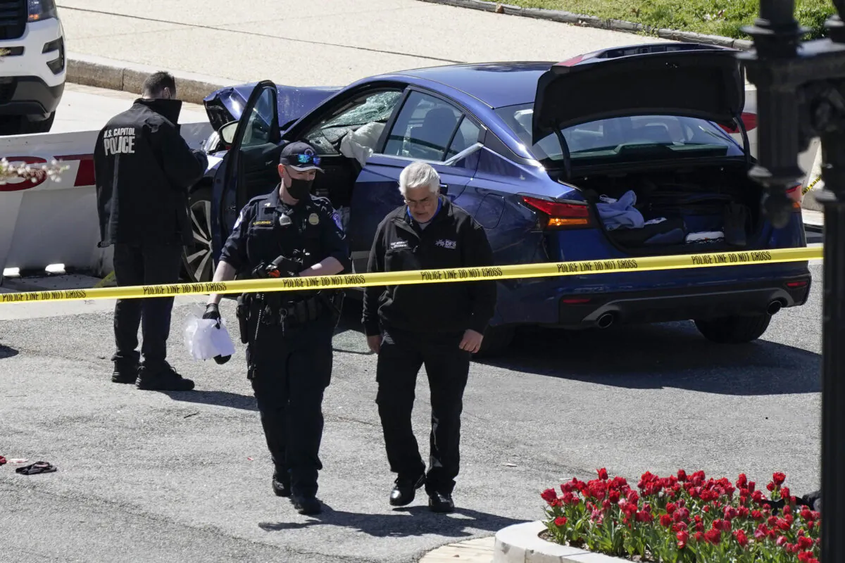 U.S. Capitol Police officers are seen near a car that was driven into a barrier on Capitol Hill in Washington on April 2, 2021. (J. Scott Applewhite/AP Photo)