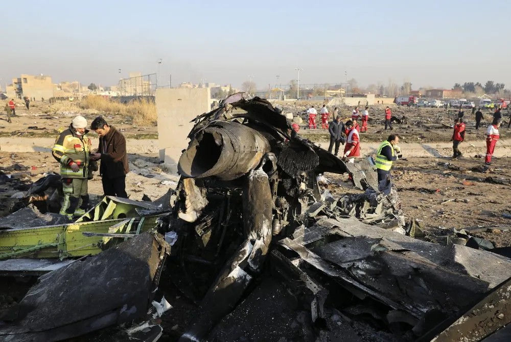 FILE - In this Jan. 8, 2020, file photo, debris at the scene where a Ukrainian plane crashed in Shahedshahr southwest of the capital Tehran, Iran. Iranian media are quoting the outgoing military prosecutor of Tehran as saying that 10 officials have been indicted for the 2020 shootdown of a Ukrainian passenger plane. (AP Photo/Ebrahim Noroozi, File)