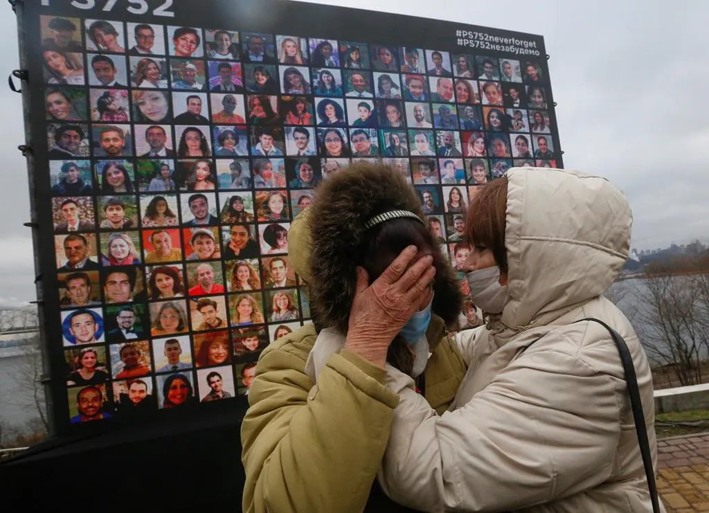 Relatives react at a memorial in Kyiv, Ukraine, on Jan. 8, 2021, for the victims of a Ukrainian 737-800 plane crash on the outskirts of Tehran.Ten officials have been indicted in Iran over the 2020 military shootdown of a Ukrainian passenger plane that killed 176 people, but the move did nothing to quell Canadian demands for accountability on April 6. (Efrem Lukatsky/The Canadian Press/AP)