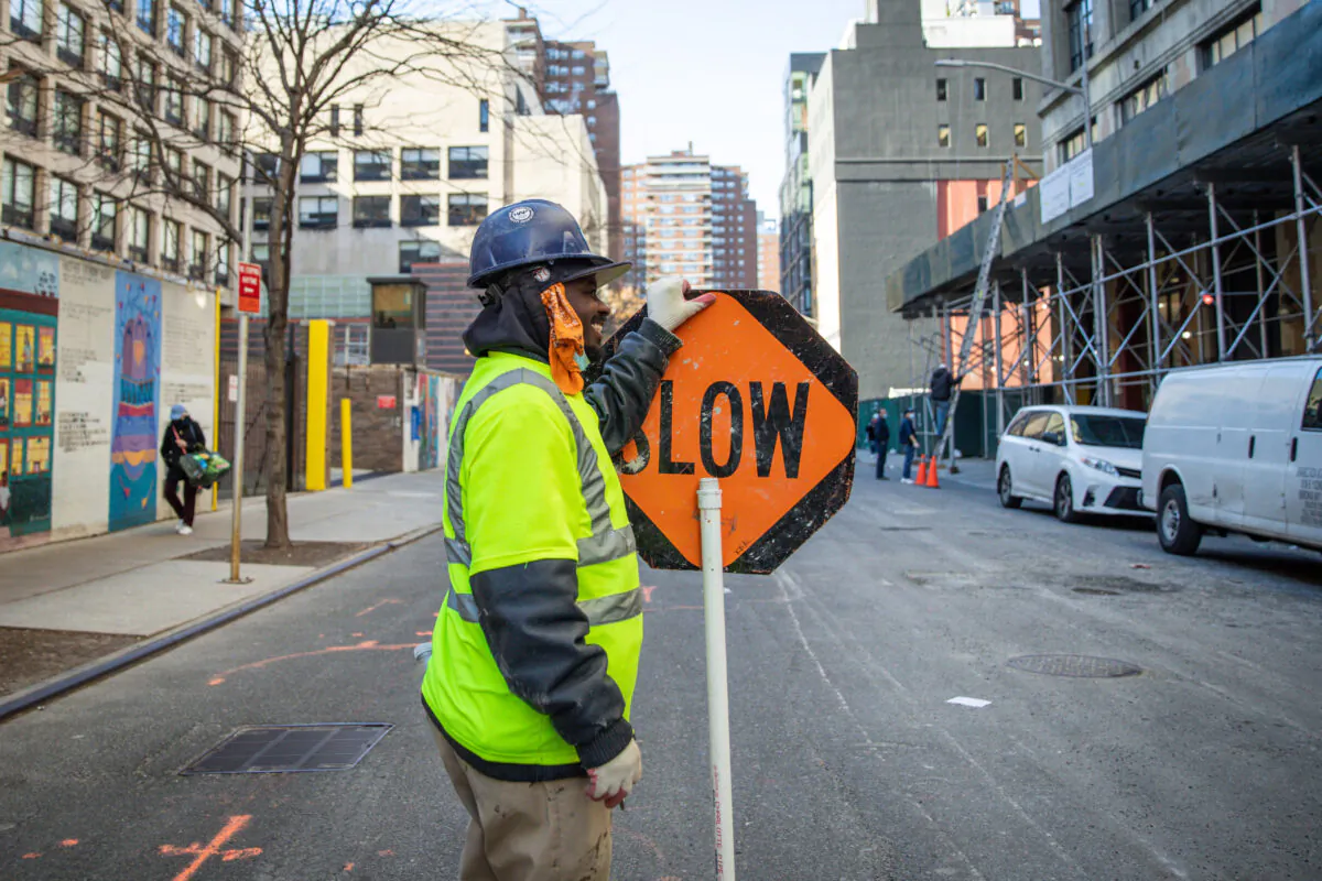 A construction worker holds a traffic sign in Manhattan, New York City, on Nov. 20, 2020. (Samira Bouaou/The Epoch Times)
