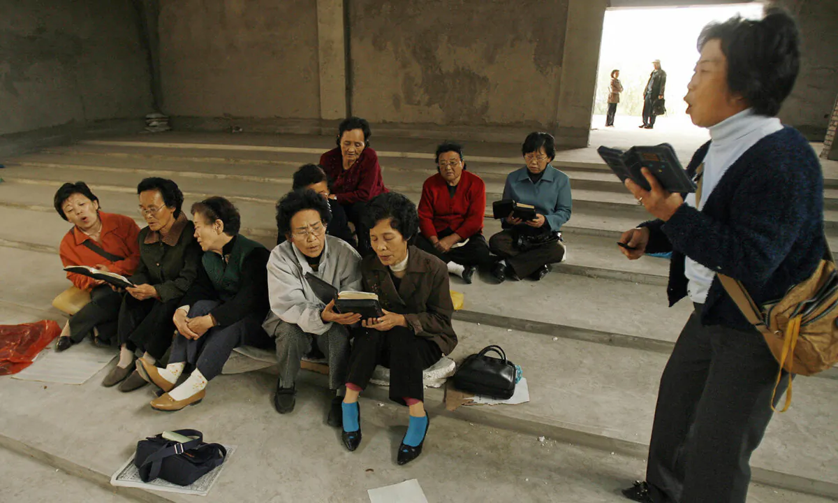 Ethnic Korean Christians sing hymns in their half-finished church in the town of Yanji in Yanbian Korean Autonomous Prefecture on the China/North Korea border on Oct. 13, 2006. (PETER PARKS/AFP via Getty Images)