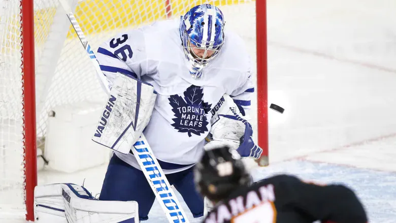 Toronto Maple Leafs goalie Jack Campbell makes a save on Calgary Flames' Sean Monahan during the second period of Toronto's 5-3 road win on the night of April 5 in Calgary. (Larry MacDougal/The Canadian Press)