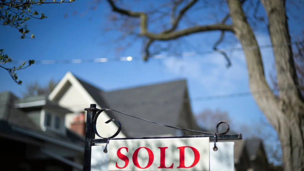 A real estate "sold" sign is shown in a Toronto west end neighbourhood on May 17, 2020. (Graeme Roy/The Canadian Press)