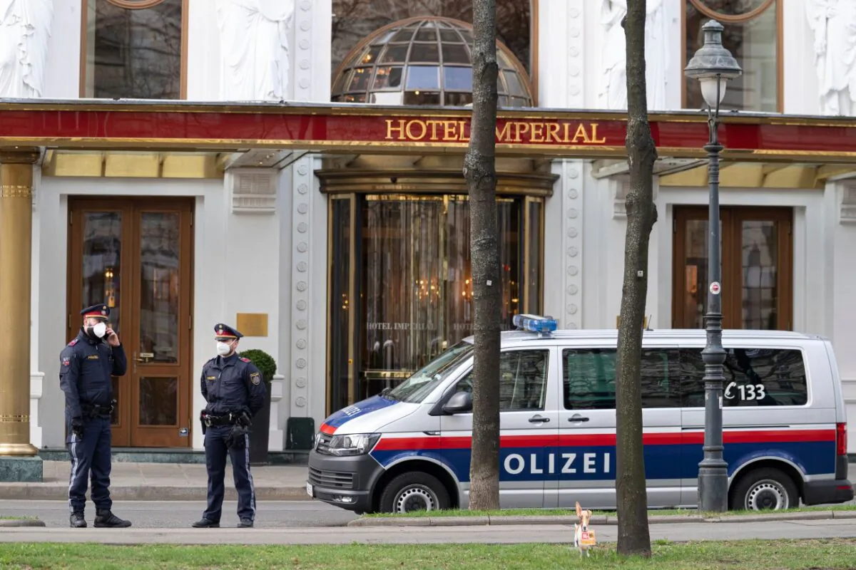 Police officers stand in front of Hotel Imperial where a delegation from Iran is staying in Vienna, Austria, on April 6, 2021. (Florian Schroetter/AP Photo)