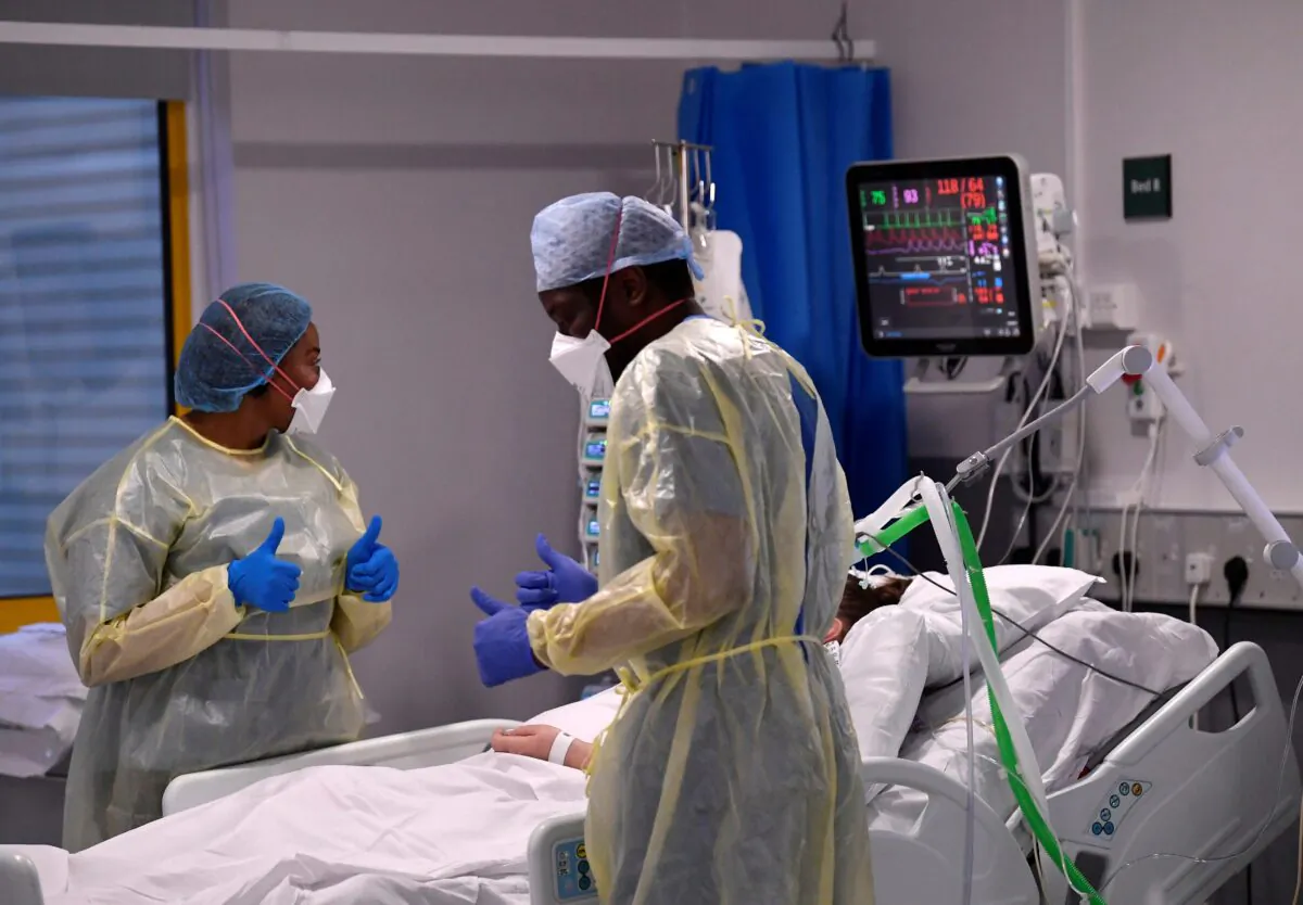 Nurses react as they treat a COVID-19 patient in the ICU (Intensive Care Unit) at Milton Keynes University Hospital, amid the spread of the coronavirus disease (COVID-19) pandemic, Milton Keynes, Britain, on Jan. 20, 2021. (Toby Melville/Reuters)