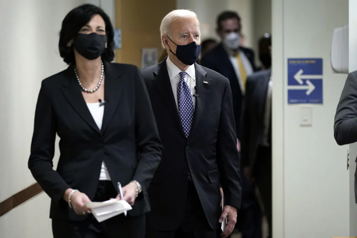 Dr. Rochelle Walensky, director of the Centers for Disease Control and Prevention, leads President Joe Biden into the room for a COVID-19 briefing at the headquarters for the CDC in Atlanta, Ga., on March 19, 2021. (Patrick Semansky/AP Photo)