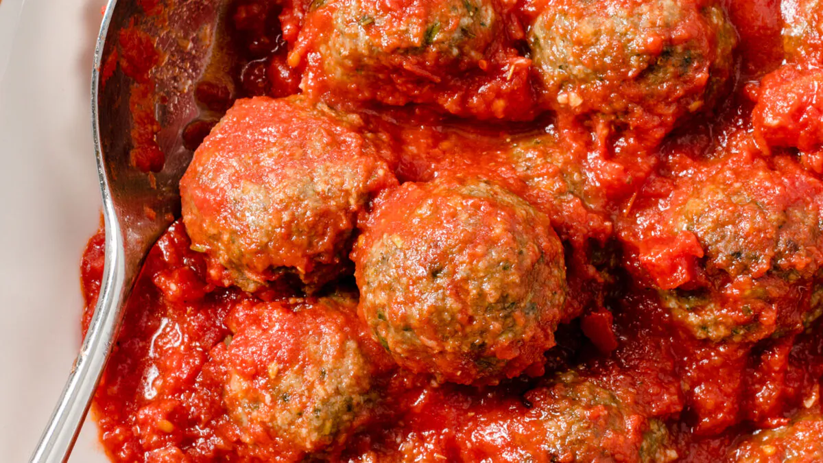 Adding pesto gives these meatballs a big boost of flavor. Will you have them on pasta or on a sub roll? (America’s Test Kitchen/TNS)