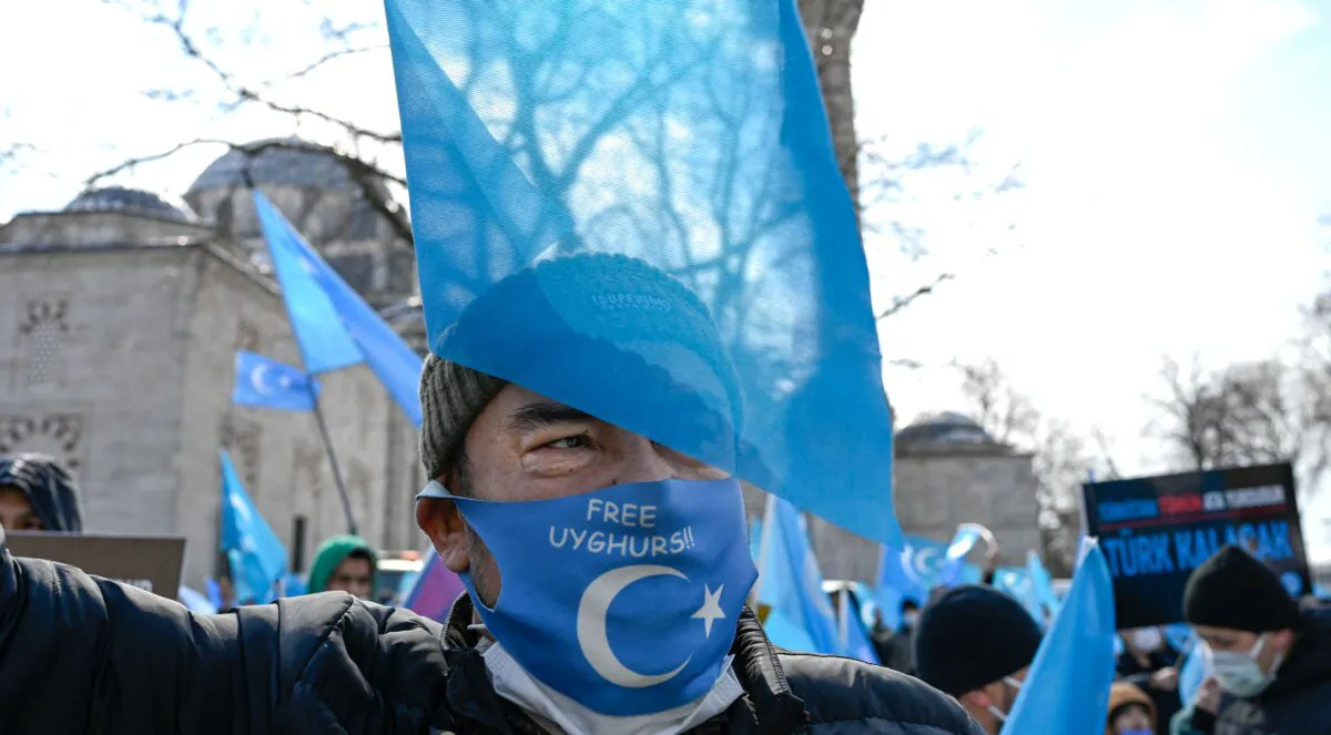 A protester from the Uyghur community living in Turkey attends a protest against the visit of China's Foreign Minister to Turkey, in Istanbul on March 25, 2021. (Bulent Kilic/AFP via Getty Images)