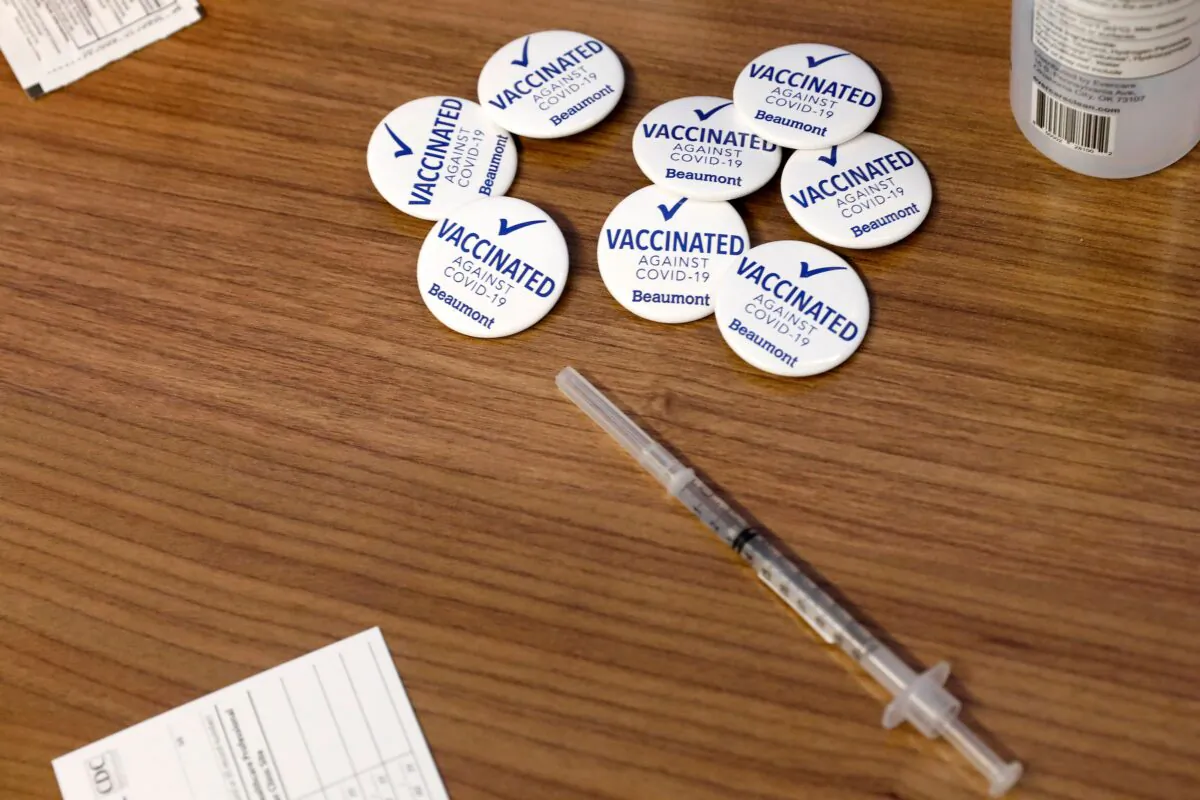 Pins for Beaumont Health Care workers after receiving their first dose of the Pfizer/BioNTech COVID-19 vaccine are seen next to a syringe at their service center in Southfield, Mich., on Dec. 15, 2020. (Jeff Kowalsky/AFP via Getty Images)