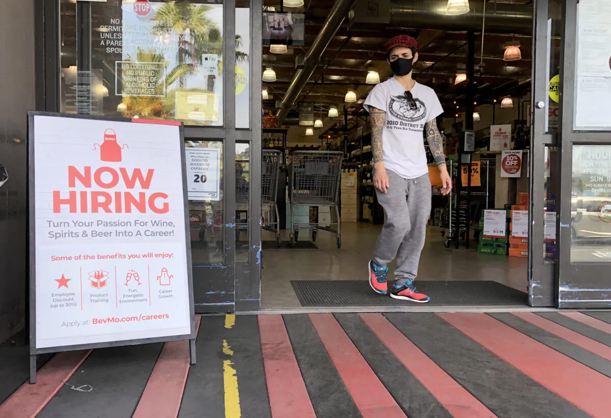 A customer walks by a now hiring sign at a BevMo store in Larkspur, Calif., on April 2, 2021. (Justin Sullivan/Getty Images)