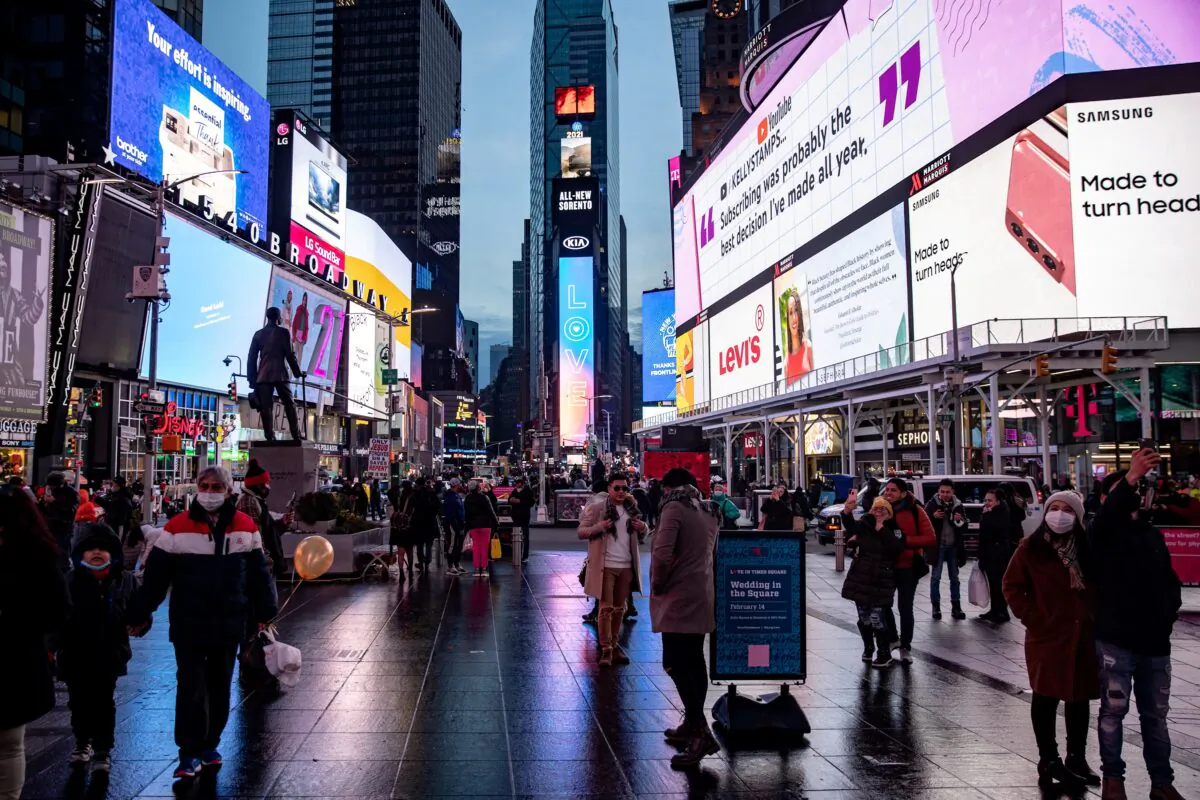 People take a selfie during Valentine's Day in Times Square in Manhattan, New York City on Feb. 14, 2021. (Jeenah Moon/Reuters)