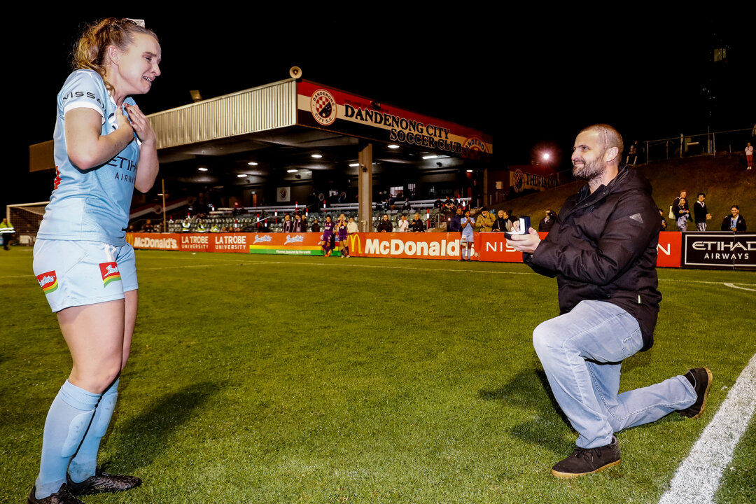 Matt Stonham proposing to Rhali Dobson after her final match at Frank Holohan Reserve in Melbourne, Australia, on March 25, 2021. (Darrian Traynor/Getty Images)
