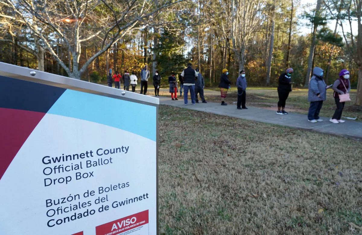 Voters stand in line to cast their ballots during the first day of early voting in the U.S. Senate runoffs at Lenora Park, in Atlanta, Ga., on Dec. 14, 2020. (Tami Chappell/AFP via Getty Images)