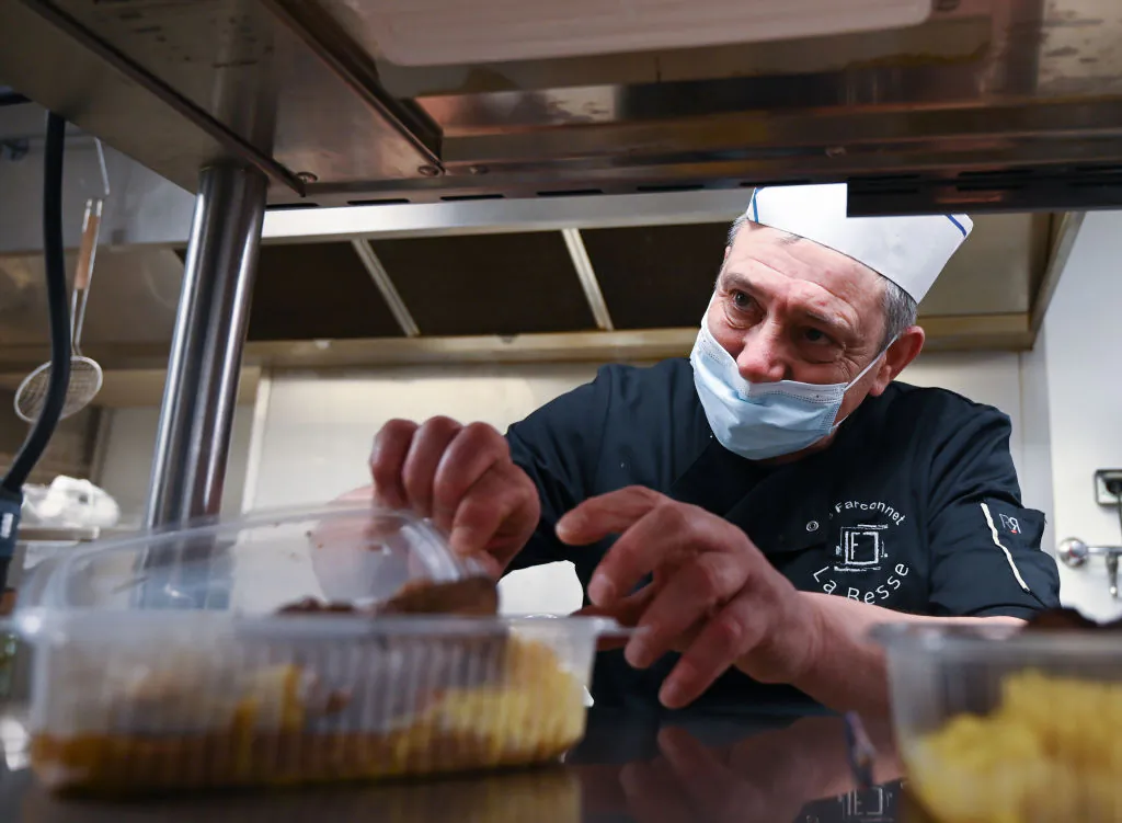 French owner of the 'Farconnet' restaurant Eric Besson, 55, prepares food in his kitchen as he cooks for construction industry workers in Tournon-sur-Rhone, France, on Feb. 2, 2021. (Philippe Desmazes / AFP via Getty Images)