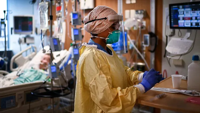 ICU health-care worker Jannikka Navaratnam cares for a patient inside a negative pressure room at the Humber River Hospital during the COVID-19 pandemic in Toronto on Dec. 9, 2020. (Nathan Denette/The Canadian Press)