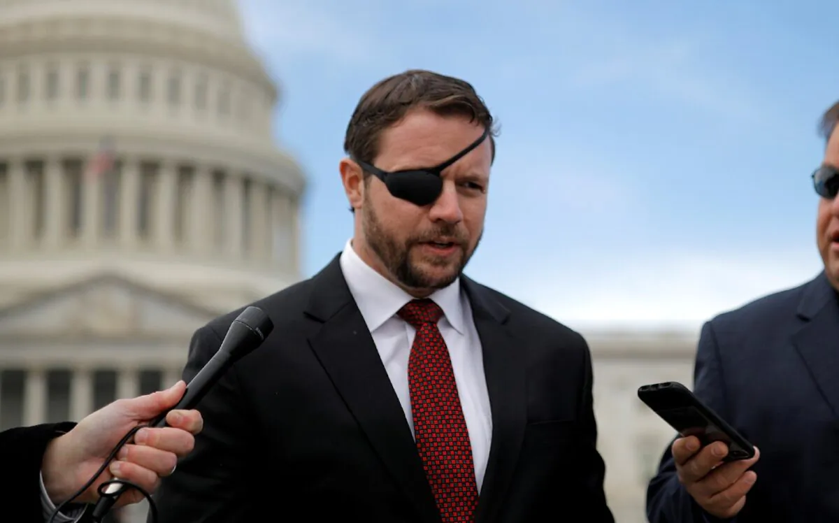 Rep.-elect Dan Crenshaw (R-Texas) talks with reporters as he arrives for a class photo with incoming newly elected members of the House of Representatives on Capitol Hill in Washington (Carlos Barria/Reuters)