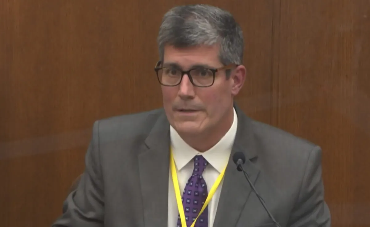 In this image from video, Dr. Andrew Baker, Hennepin County Medical Examiner, testifies as Hennepin County Judge Peter Cahill presides in the trial of former Minneapolis police Officer Derek Chauvin at the Hennepin County Courthouse in Minneapolis, on April 9, 2021. (Court TV via AP/Pool)