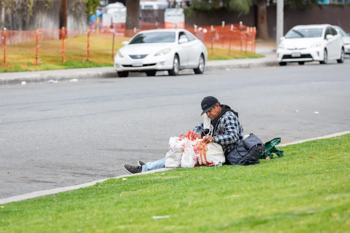 A homeless man rests near Orange, Calif. (John Fredricks/The Epoch Times)