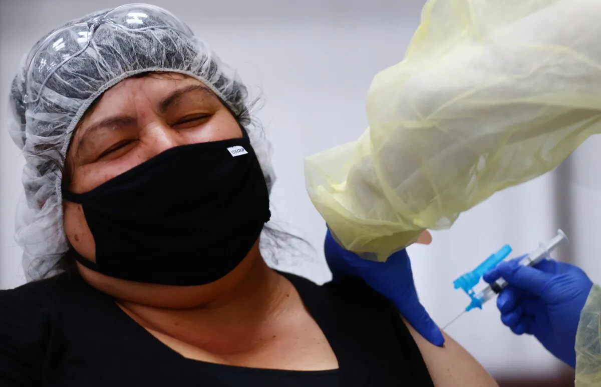 Eloina Galvez receives a one shot dose of the Johnson & Johnson COVID-19 vaccine at a clinic geared toward agriculture workers in Riverside, Calif., on April 5, 2021. (Mario Tama/Getty Images)