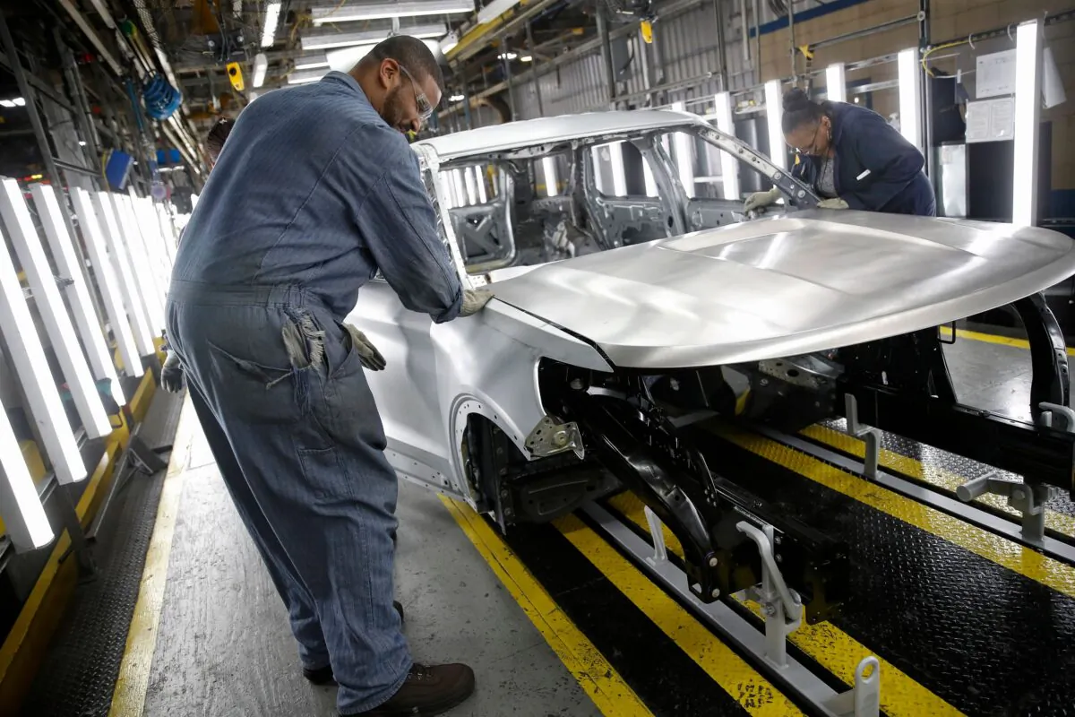 Workers assemble cars at the newly renovated Ford Assembly Plant in Chicago on June 24, 2019. (Jim Young/AFP via Getty Images)