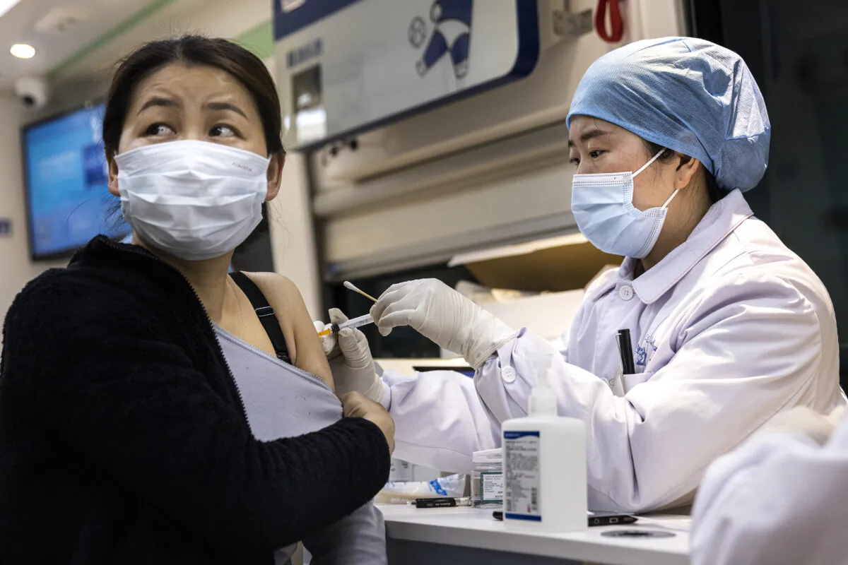 A woman receives the COVID-19 vaccine on the move vaccination vehicle in Wuhan, China on April 8, 2021. (Getty Images)