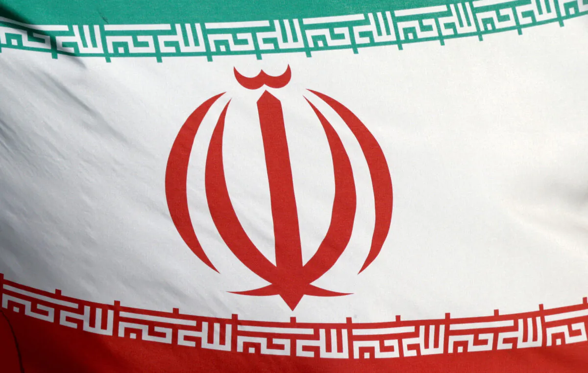 The Iranian flag waves in front of the International Atomic Energy Agency (IAEA) headquarters in Vienna, Austria, on March 1, 2021. (Lisi Niesner/Reuters)