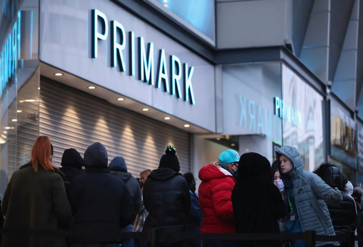 Customers queue to enter as retail store Primark in Birmingham, Britain, reopens its doors after a third lockdown imposed in early January due to the ongoing COVID-19 pandemic, on April 12, 2021. (Carl Recine/Reuters)