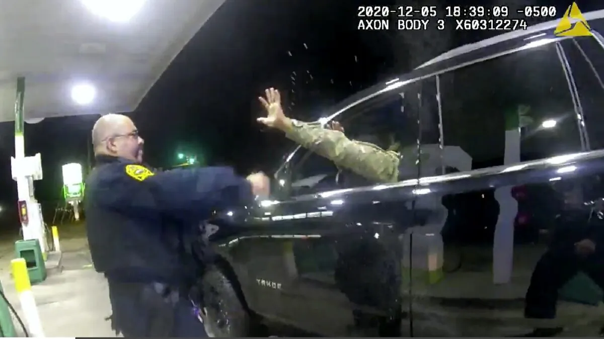 A police officer uses a spray agent on Caron Nazario on Dec. 20, 2020, in Windsor, Va.  Nazario, a second lieutenant in the U.S. Army, is suing two Virginia police officers over a traffic stop during which he says the officers drew their guns and pointed them at him as he was dressed in uniform.  (Windsor Police via AP)