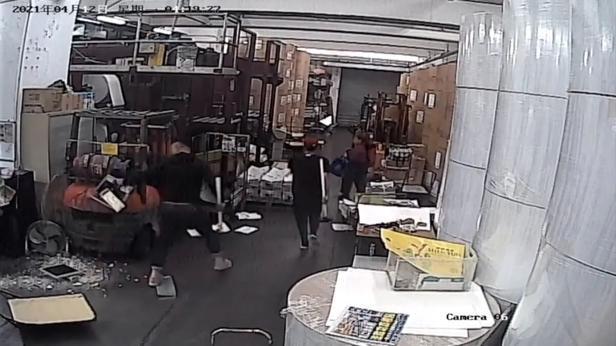 Two intruders dressed in black holding hammers caught on CCTV at the print shop that prints the Hong Kong edition of The Epoch Times on April 12, 2021. (The Epoch Times)