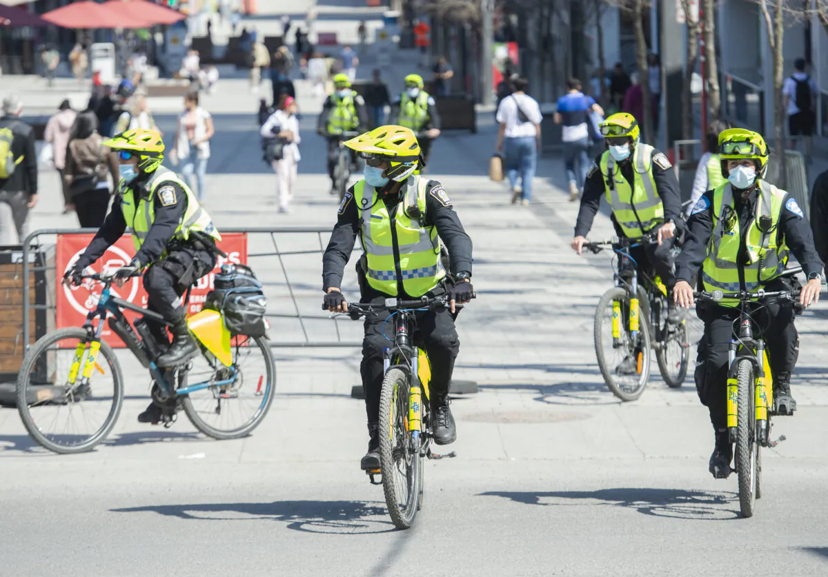 Police officers patrol Sainte-Catherine Street in Montreal on April 10, 2021. (Graham Hughes/The Canadian Press)