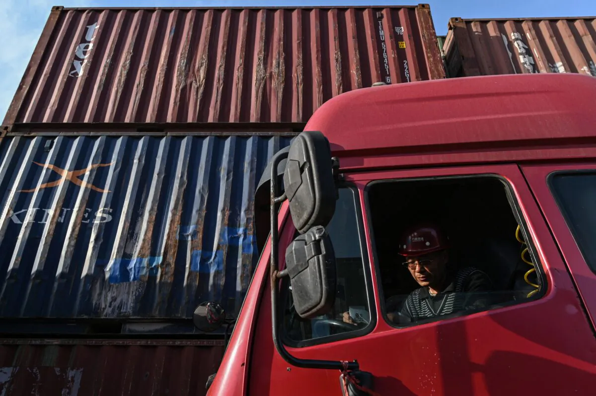 A trucker waits his turn to unload a container at the Lianyungang Port Container Terminal in Lianyungang, eastern China’s Jiangsu Province on March 24, 2021. (Hector Retamal/AFP via Getty Images)